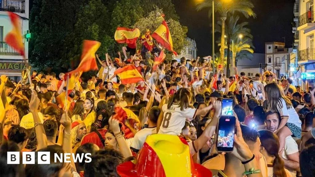 Jubilation of fans waving Spanish flags at night Jubilation of fans waving Spanish flags at night