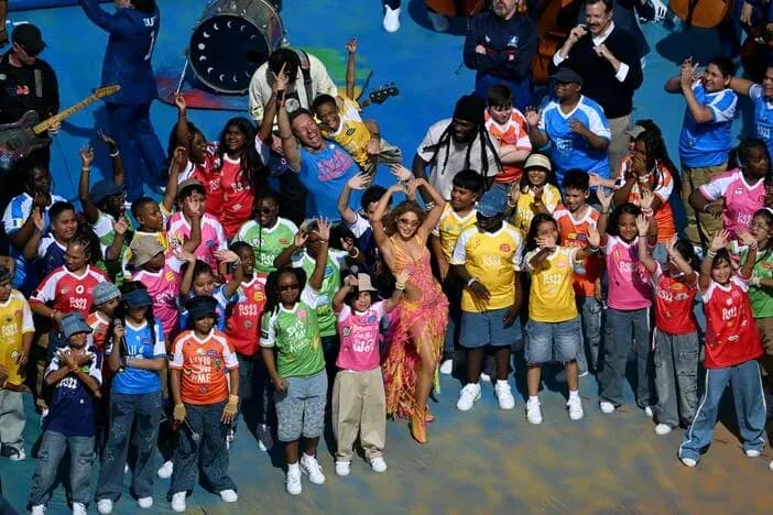 Jubilation with children and performer on stage Jubilation with children and performer on stage