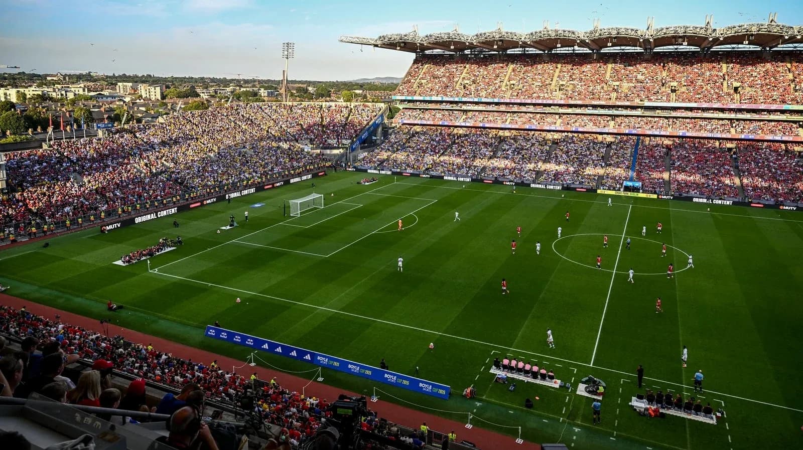 Football match in a packed stadium with fans Football match in a packed stadium with fans