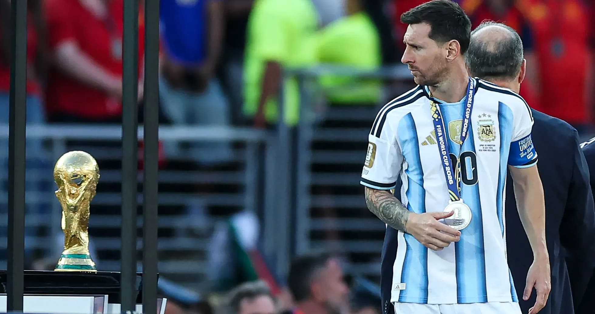 Lionel Messi with silver medal near World Cup trophy Lionel Messi with silver medal near World Cup trophy