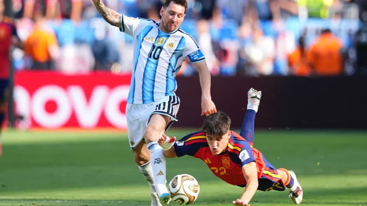 Lionel Messi evading a sliding tackle during match Lionel Messi evading a sliding tackle during match