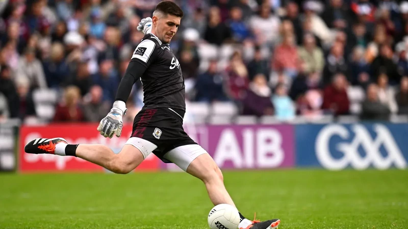 Goalkeeper kicking a football during a match Goalkeeper kicking a football during a match
