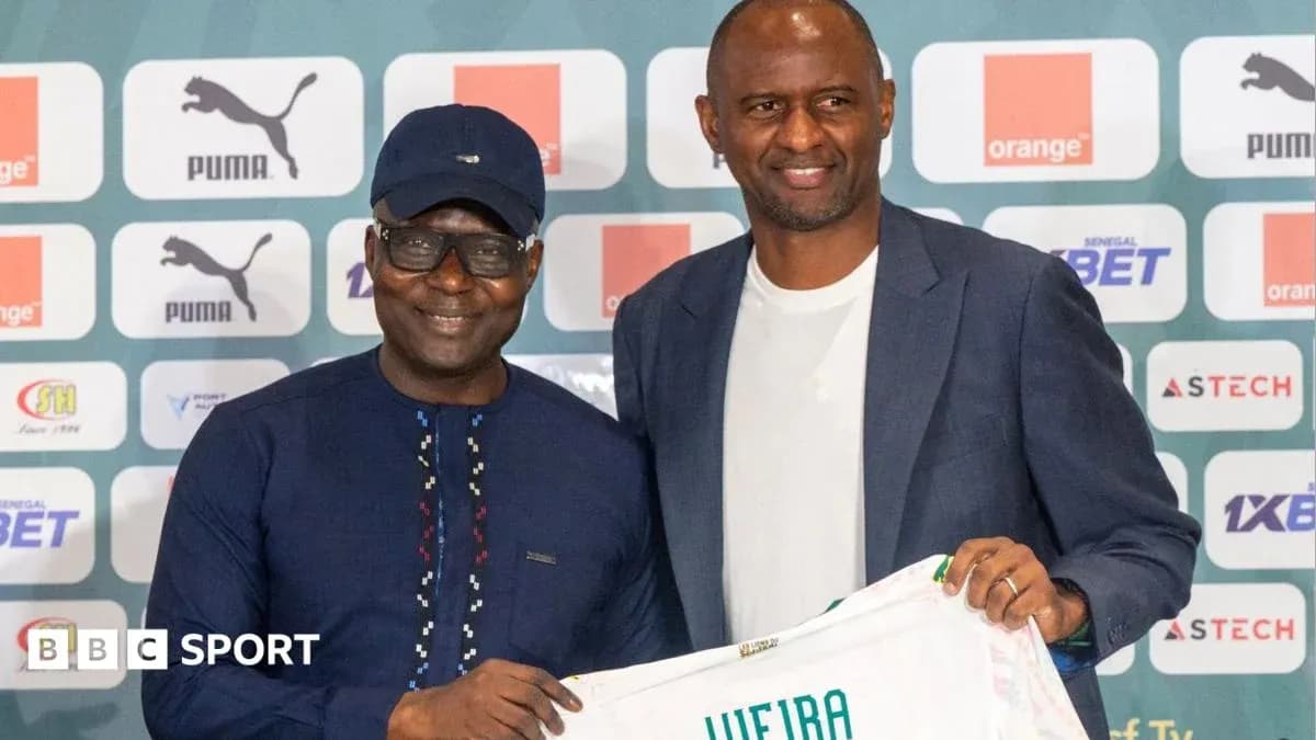 Two men posing with a football jersey at event Two men posing with a football jersey at event