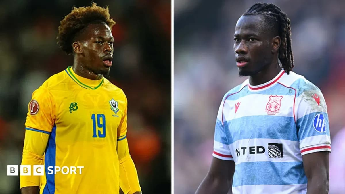 Two football players in team kits during match Two football players in team kits during match