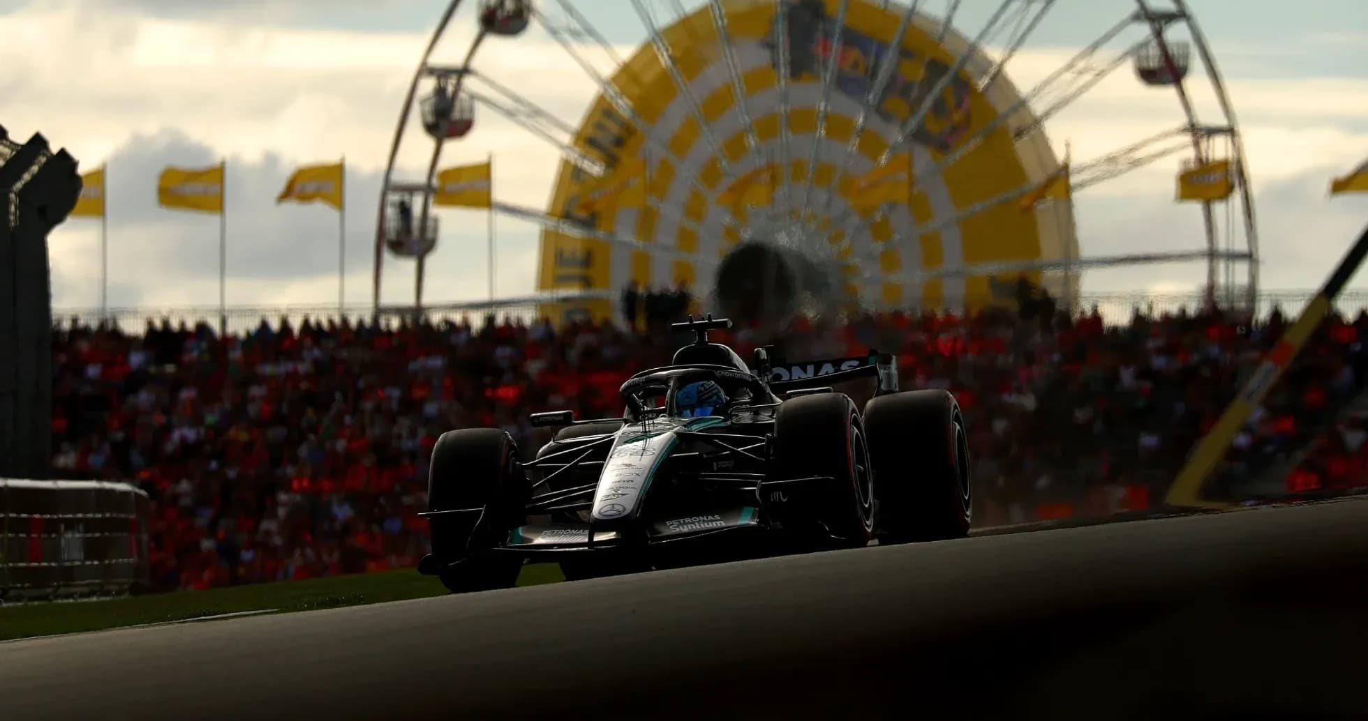 Formula 1 car racing with crowd and ferris wheel Formula 1 car racing with crowd and ferris wheel