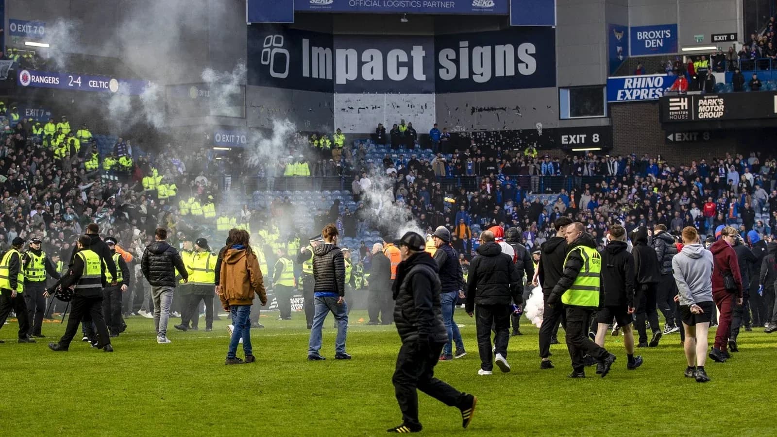 Fans and security on the pitch after match Fans and security on the pitch after match
