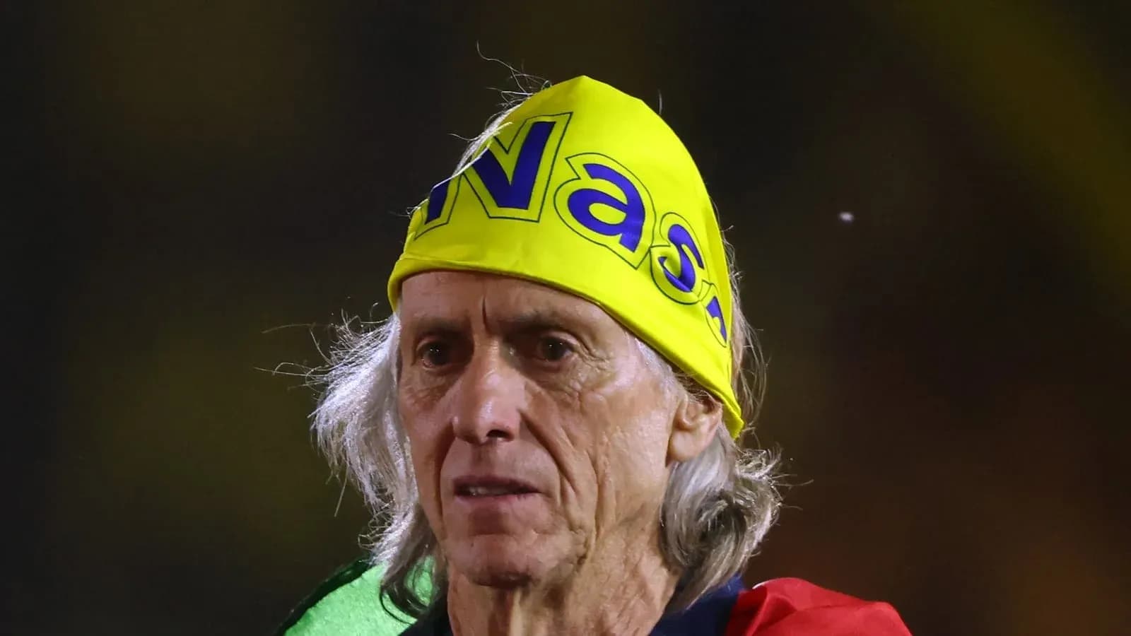 Fan wearing yellow bandana at sports event Fan wearing yellow bandana at sports event