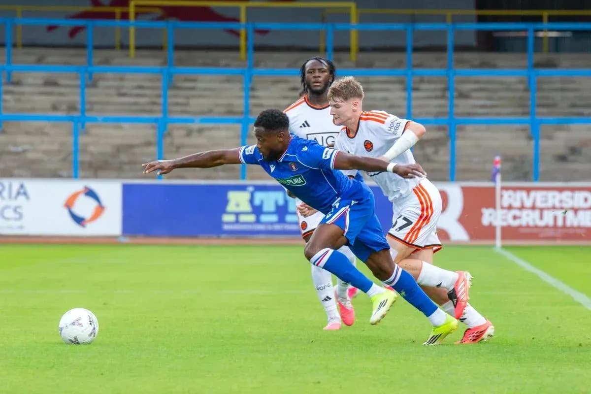 Player attempting to control the ball while tackled Player attempting to control the ball while tackled