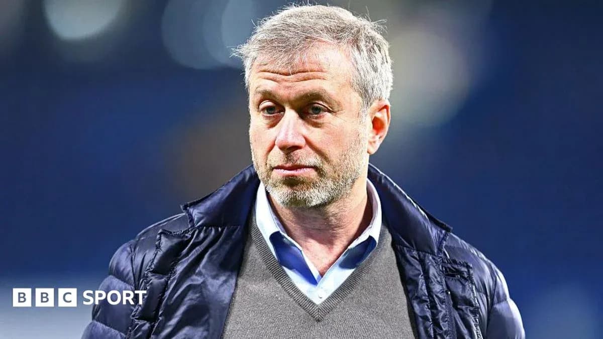 Man in a jacket standing at sports venue Man in a jacket standing at sports venue