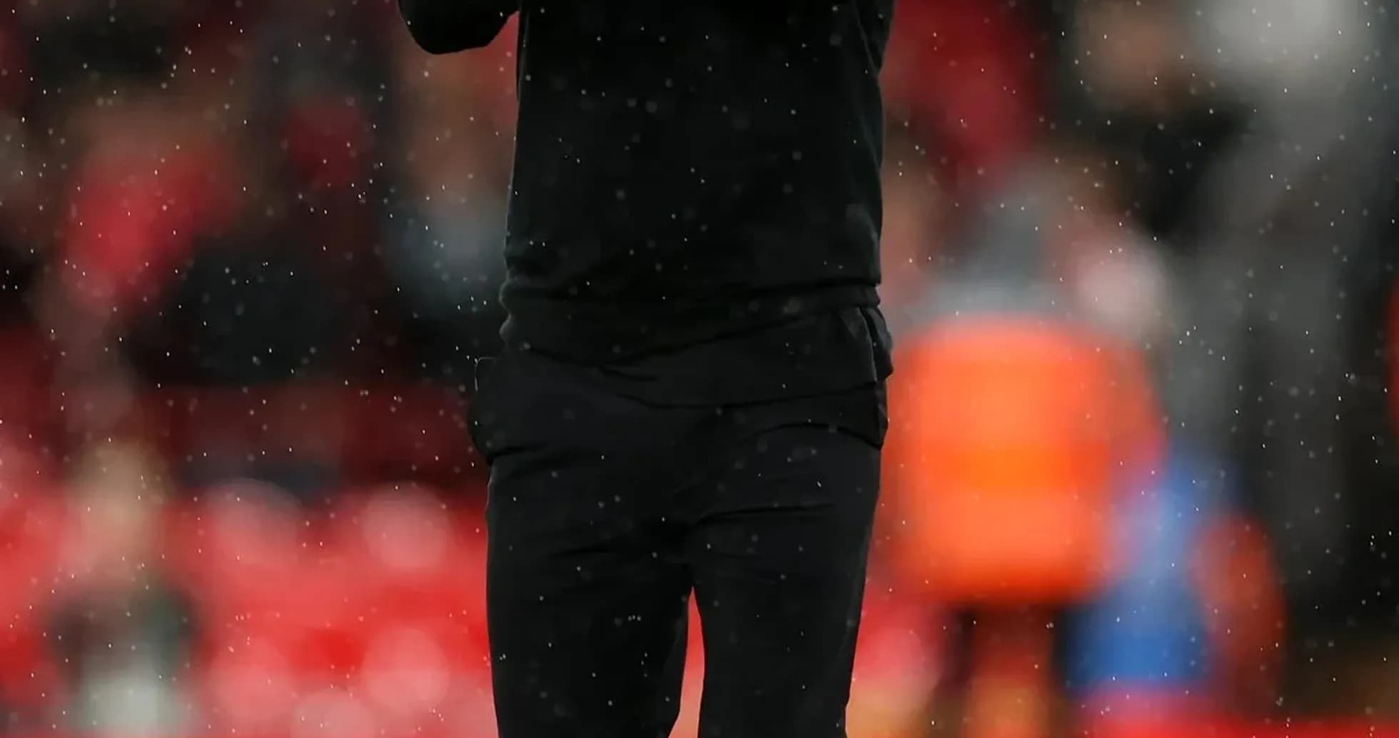 Men's football coach applauding on the pitch Men's football coach applauding on the pitch
