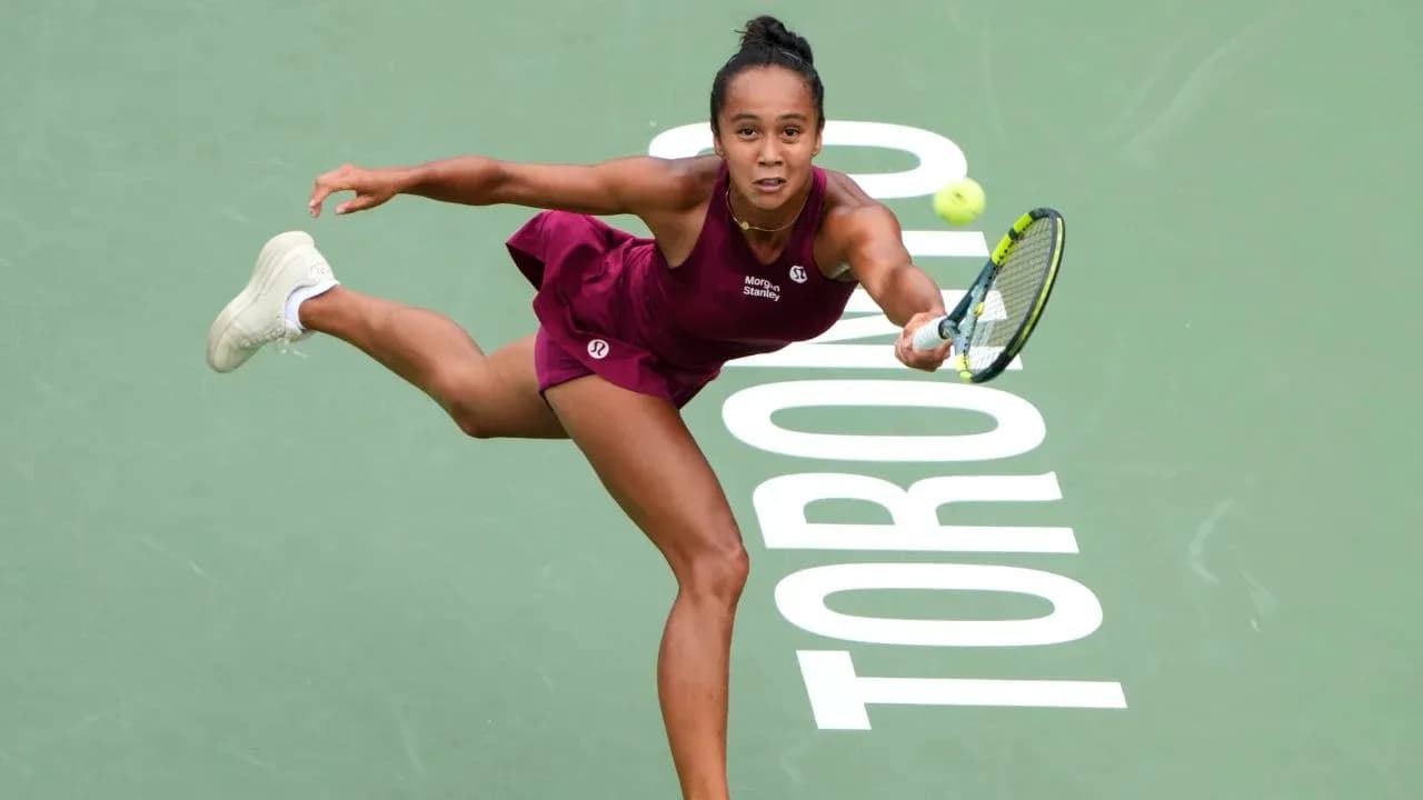 Tennis player reaching for a ball on court Tennis player reaching for a ball on court