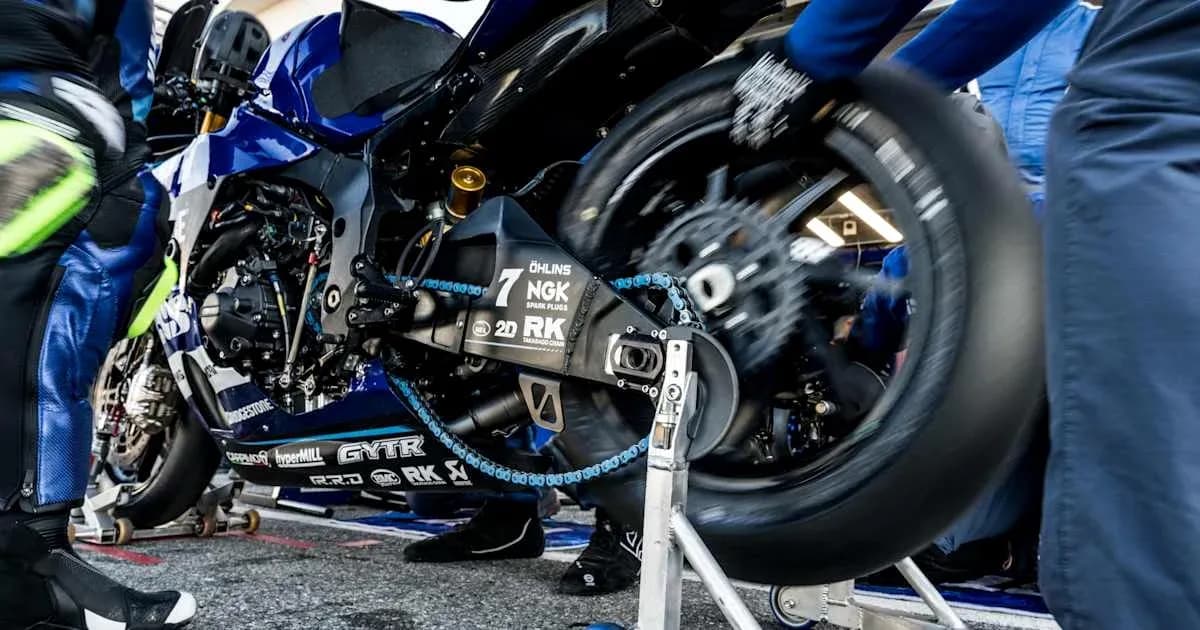MotoGP team working on motorcycle in pit area MotoGP team working on motorcycle in pit area