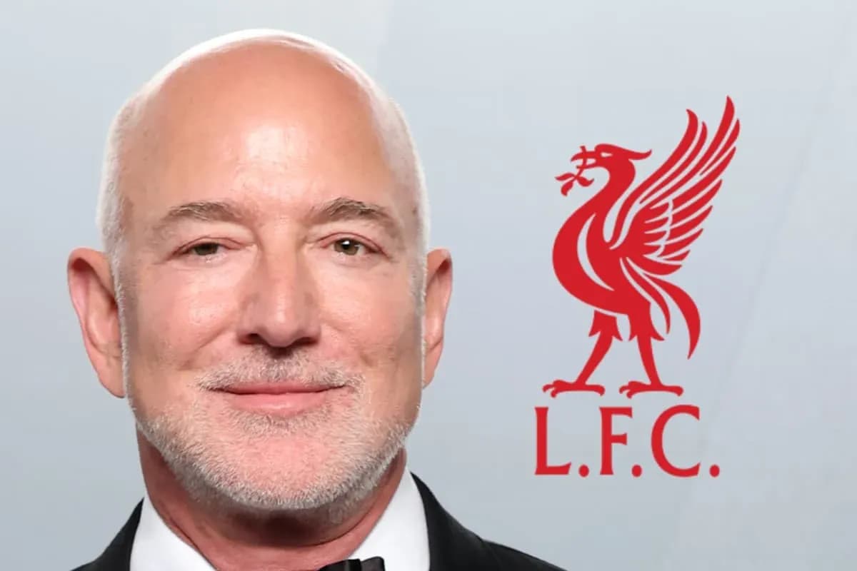 Man in tuxedo next to Liverpool FC logo Man in tuxedo next to Liverpool FC logo