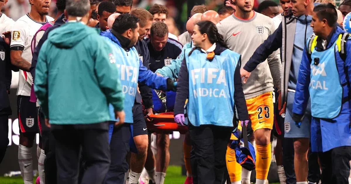 Medical staff assisting injured player off the field Medical staff assisting injured player off the field