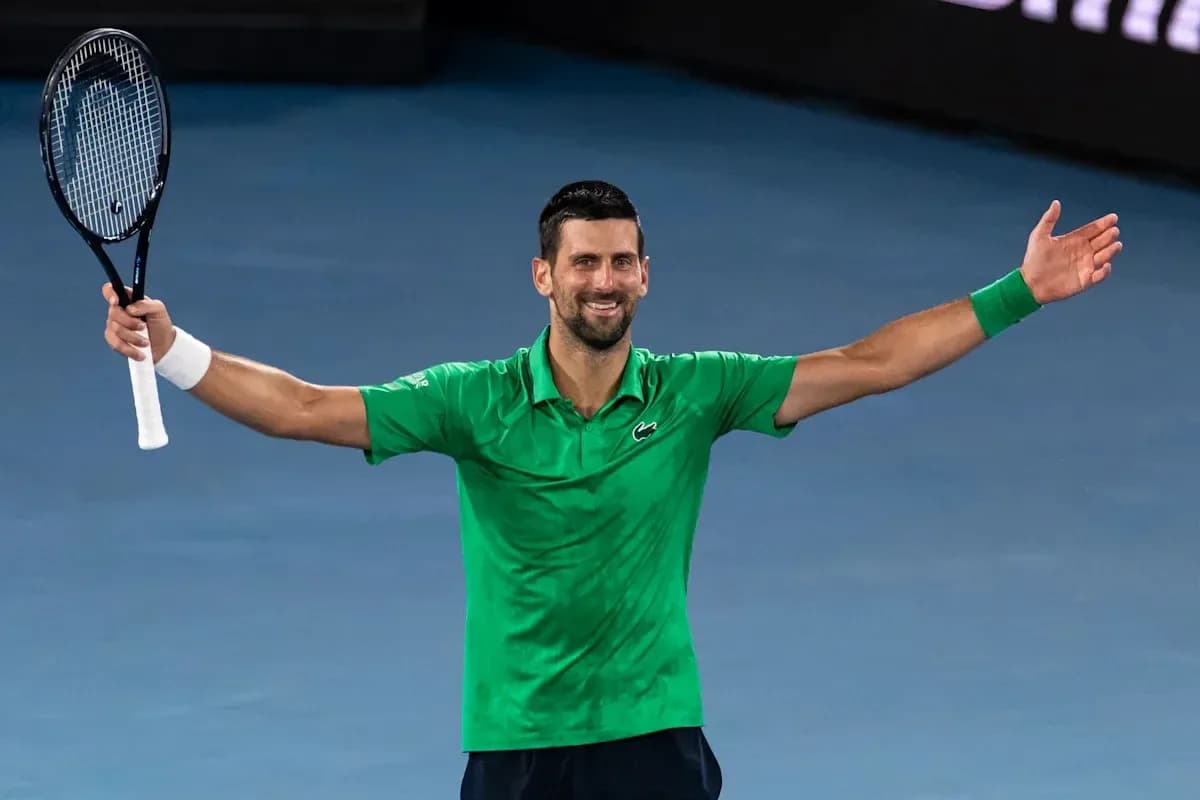 Tennis player celebrating with arms raised in victory Tennis player celebrating with arms raised in victory