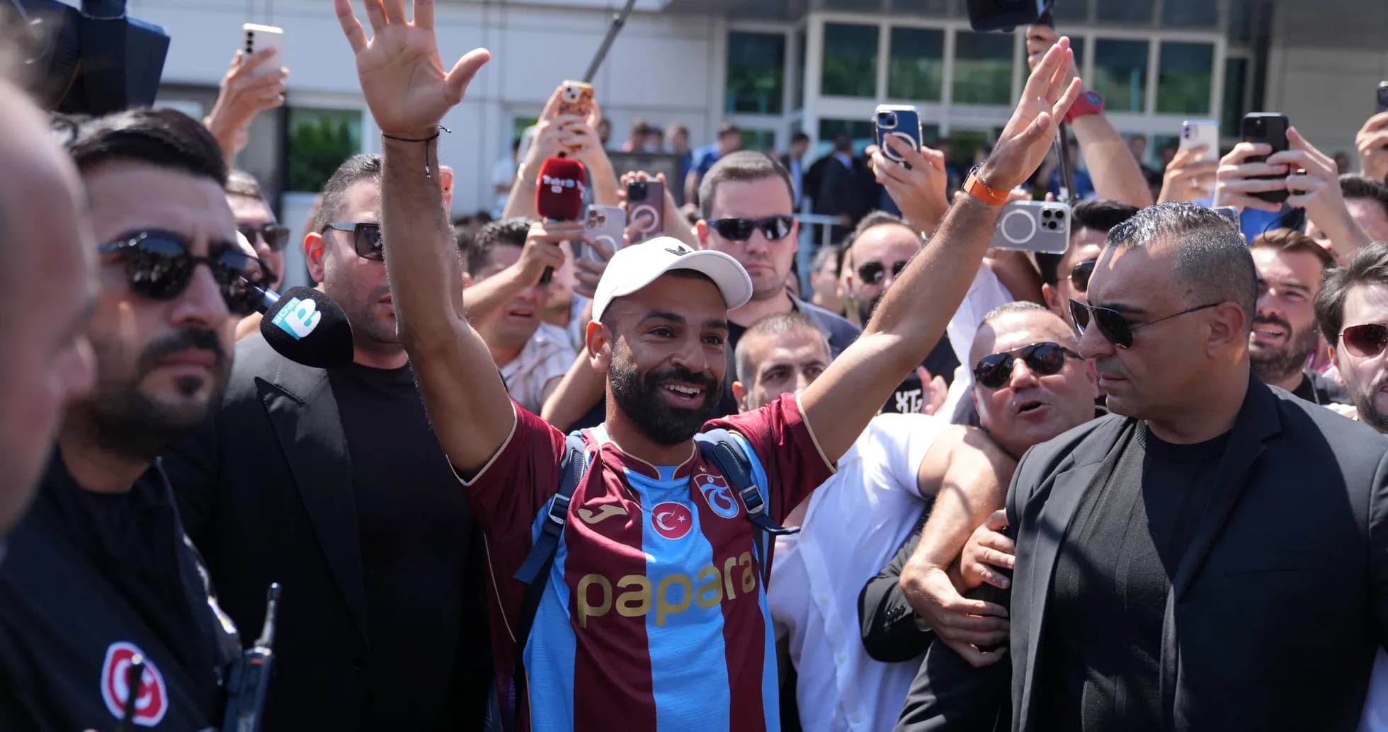 Football player greeted by fans at airport arrival Football player greeted by fans at airport arrival