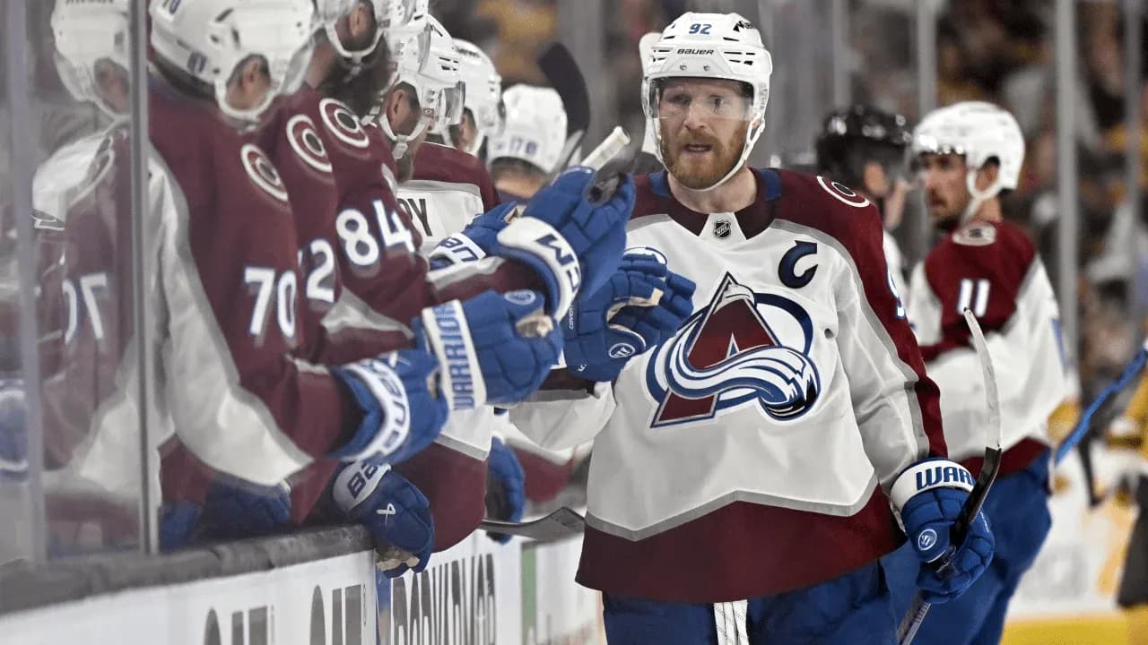 Hockey player celebrating with teammates on bench Hockey player celebrating with teammates on bench