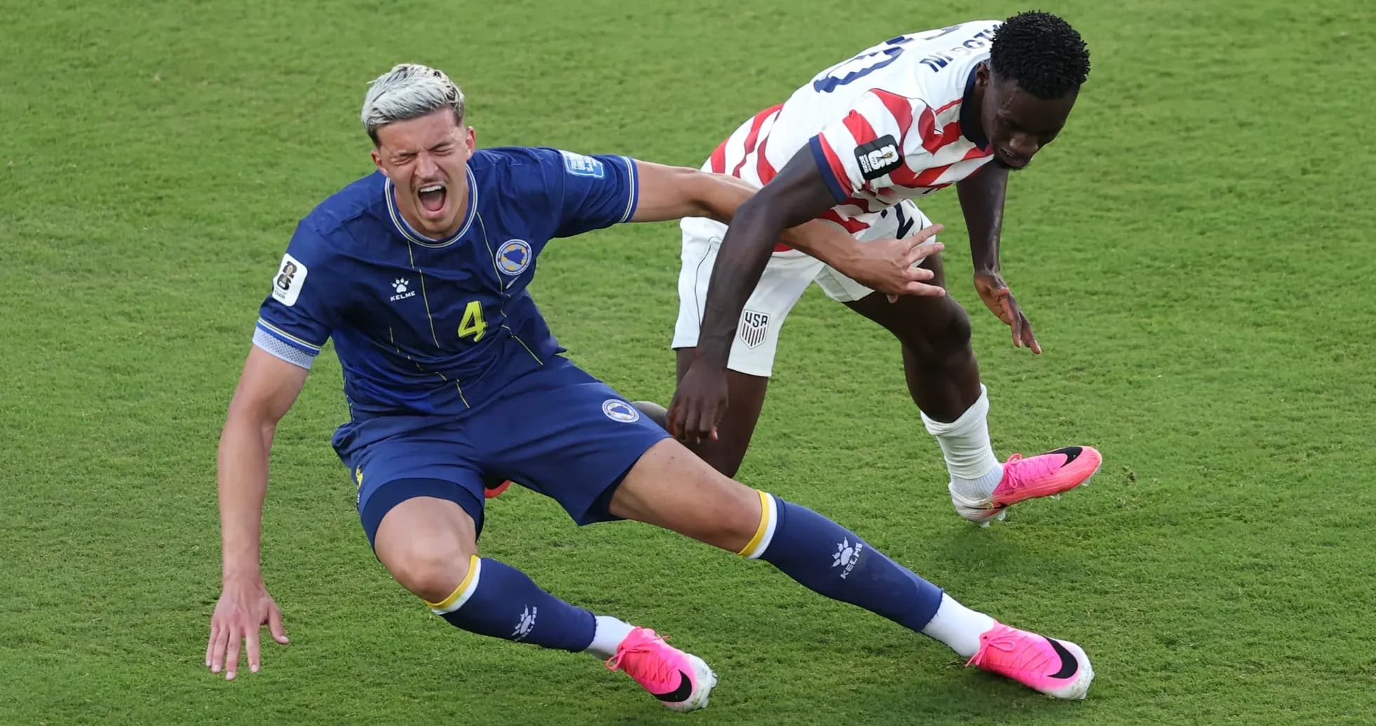Bosnia player falling while challenged by USA player Bosnia player falling while challenged by USA player