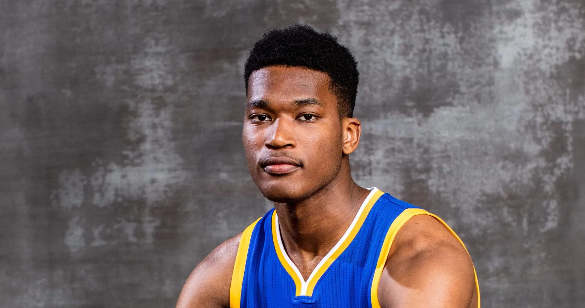 Basketball player in team jersey posing for portrait Basketball player in team jersey posing for portrait