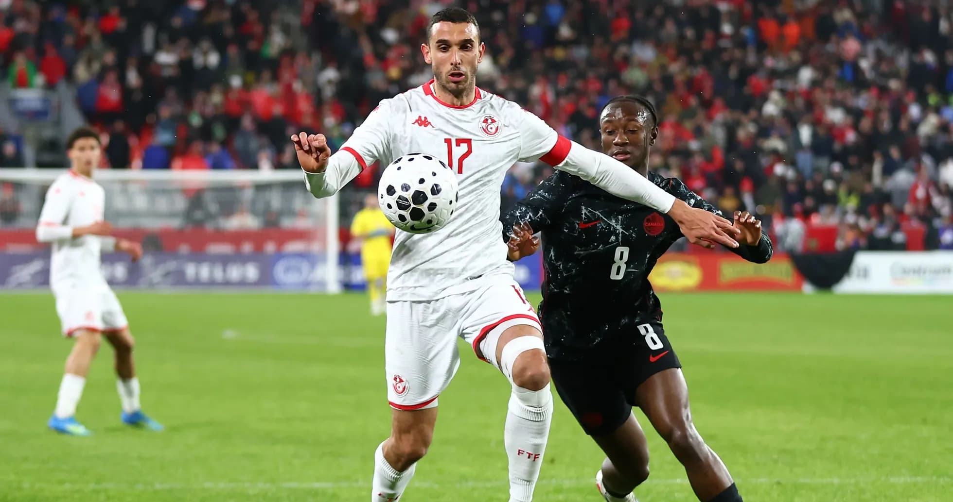 Tunisian player controls the ball against opponent Tunisian player controls the ball against opponent
