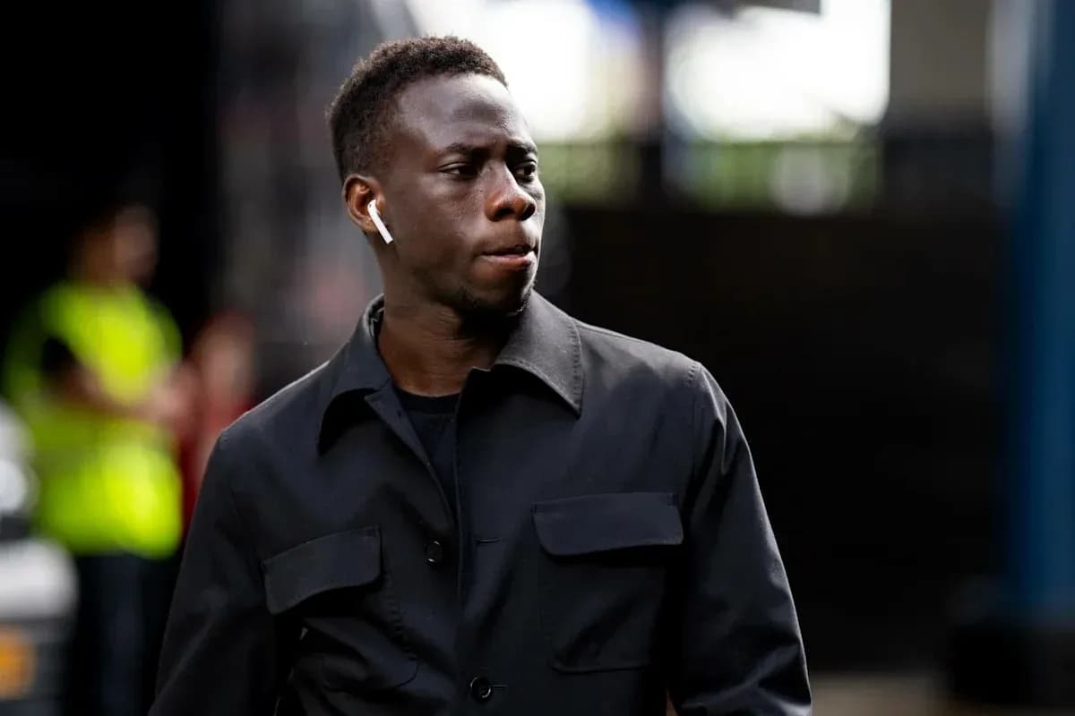 Player walking with AirPods in a black jacket Player walking with AirPods in a black jacket