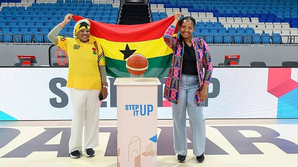 Two women holding Ghana flag with basketball on podium Two women holding Ghana flag with basketball on podium