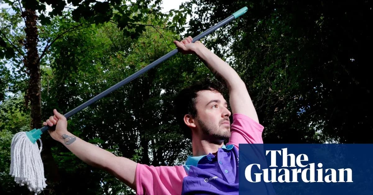 Man posing with a mop in outdoor setting Man posing with a mop in outdoor setting