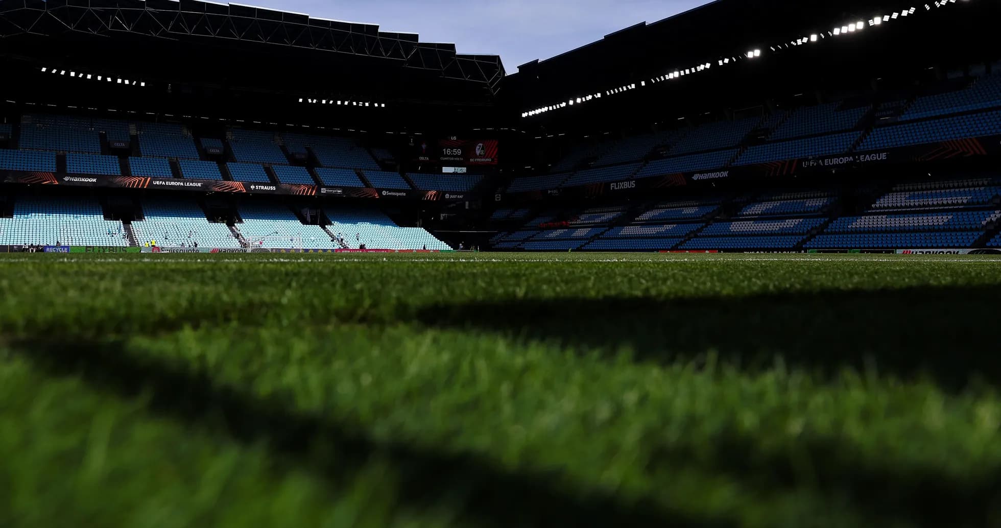 Empty stadium view with focus on grass field Empty stadium view with focus on grass field