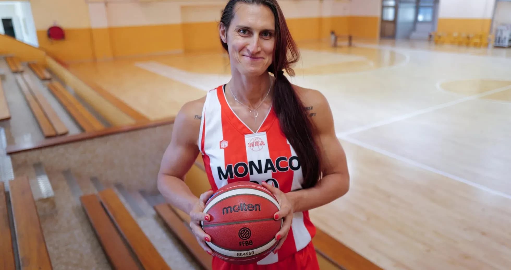 Basketball player in Monaco jersey holding ball Basketball player in Monaco jersey holding ball