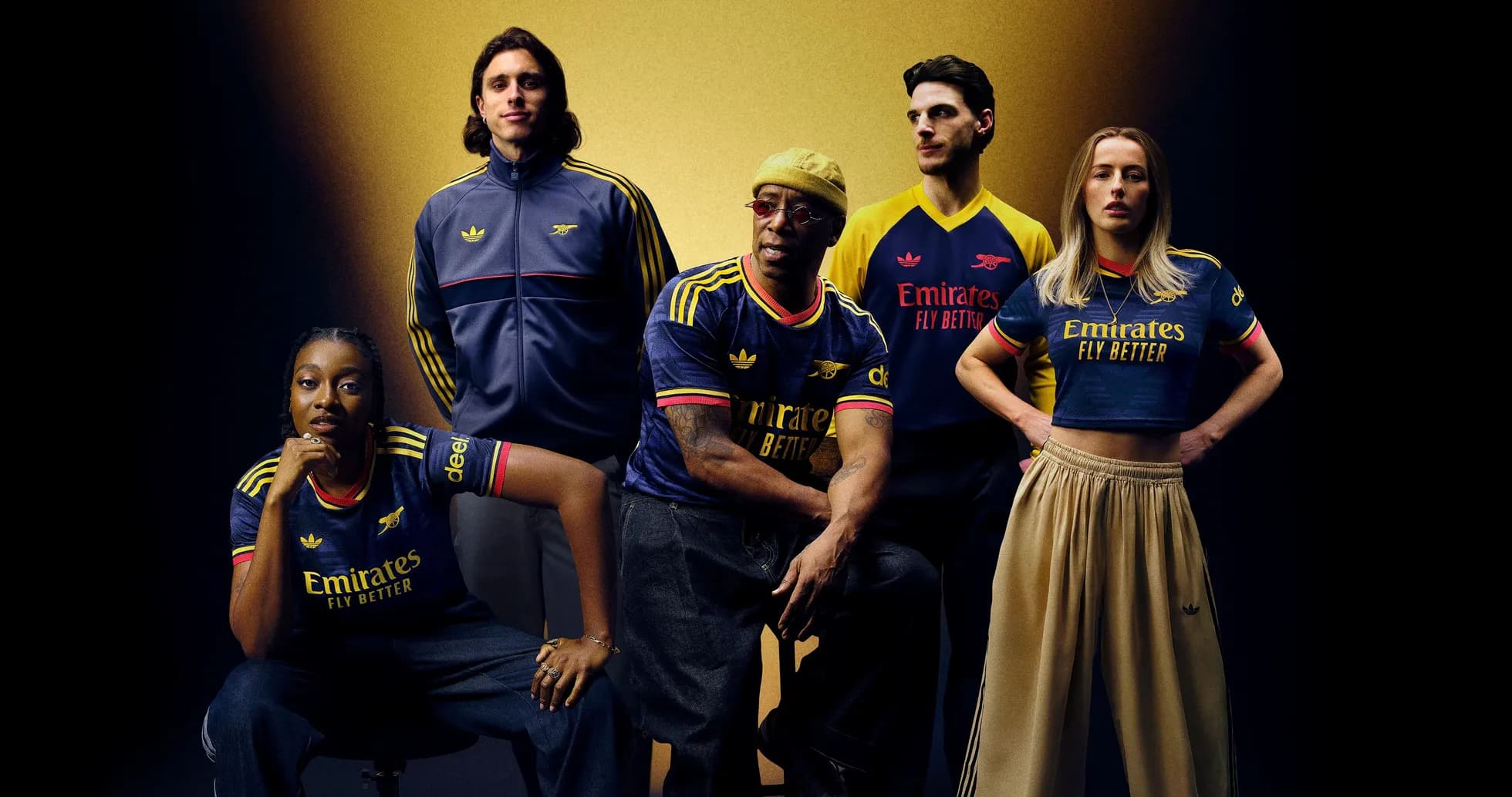 Five individuals wearing Arsenal jerseys posing together Five individuals wearing Arsenal jerseys posing together
