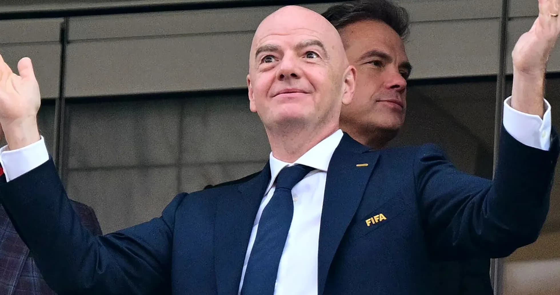 FIFA official gesturing from VIP box at event FIFA official gesturing from VIP box at event