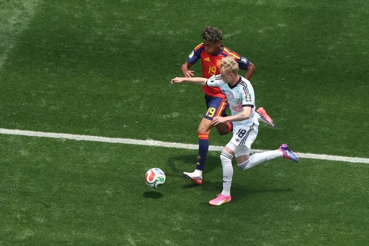 Two players contesting for the ball on field Two players contesting for the ball on field