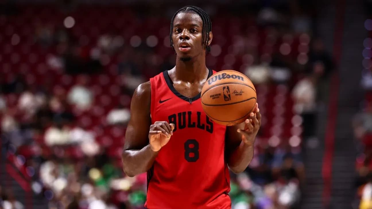 Basketball player holding ball during game warm-up Basketball player holding ball during game warm-up