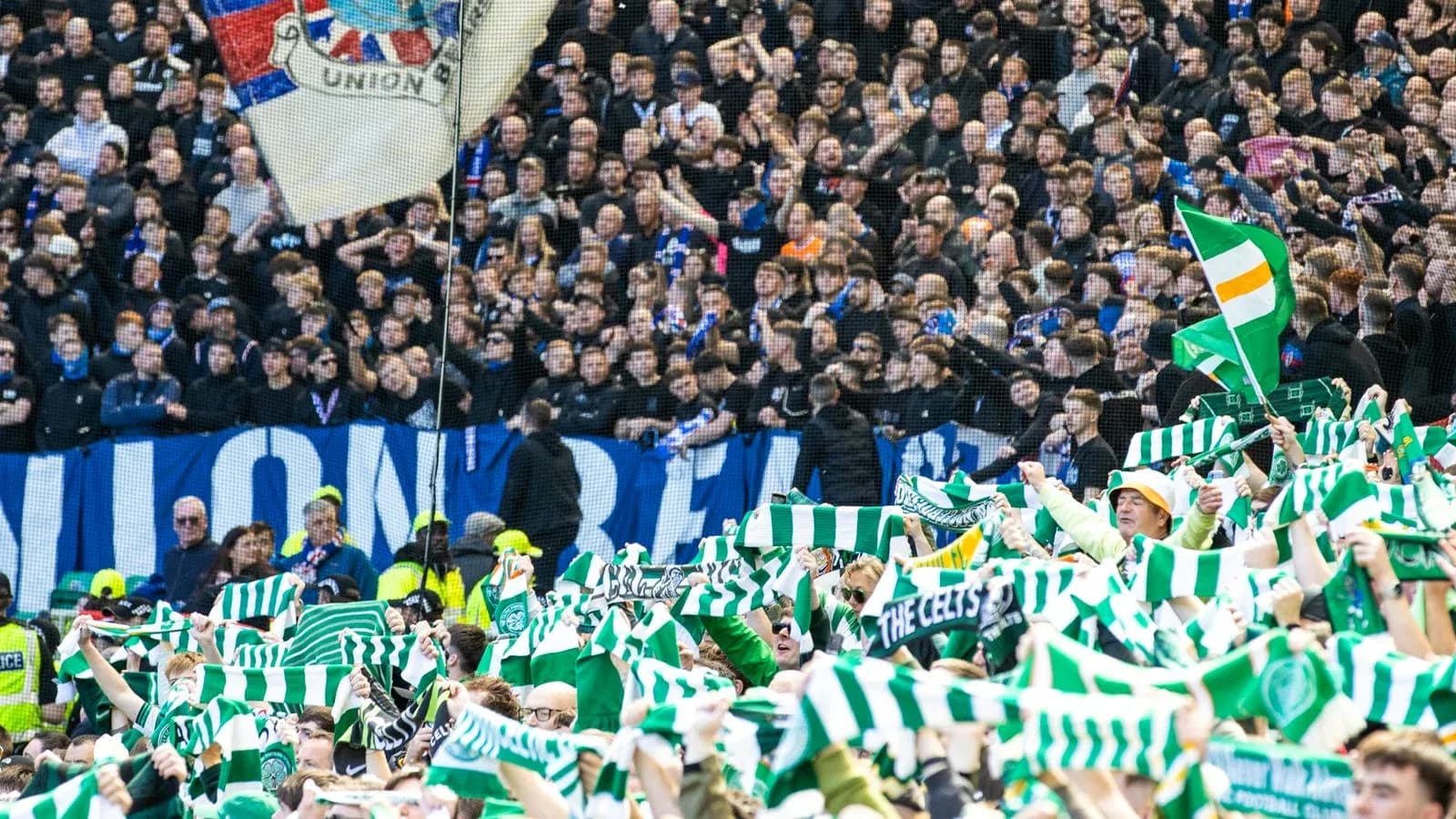 Celtic fans waving scarves at football match Celtic fans waving scarves at football match