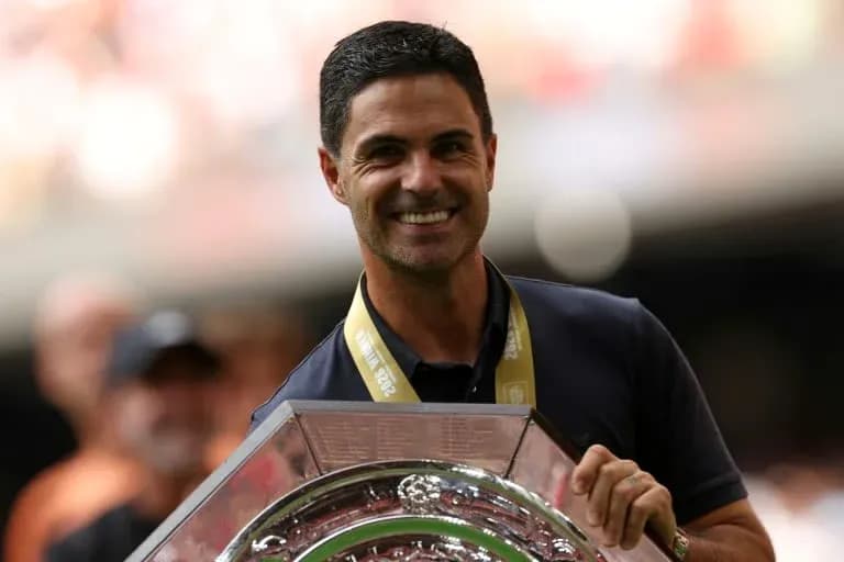 Men coach holding trophy during celebration event Men coach holding trophy during celebration event