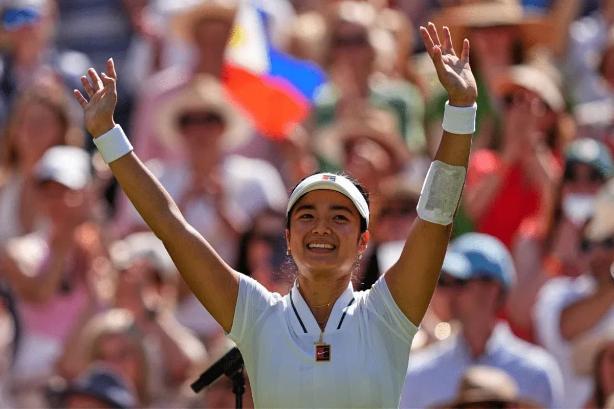 Tennis player celebrating with arms raised in crowd Tennis player celebrating with arms raised in crowd