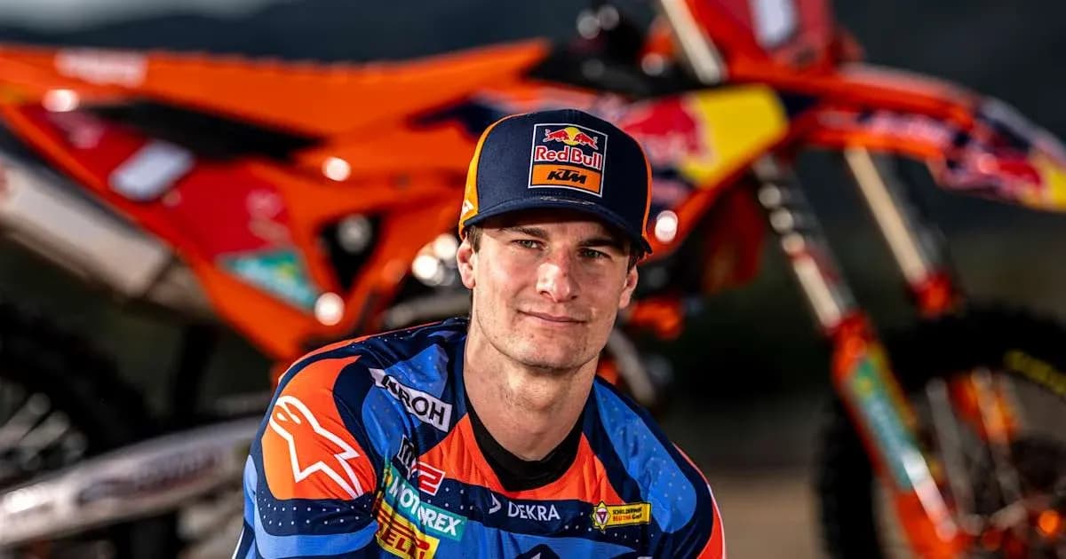 Motocross racer posing with KTM motorcycle Motocross racer posing with KTM motorcycle