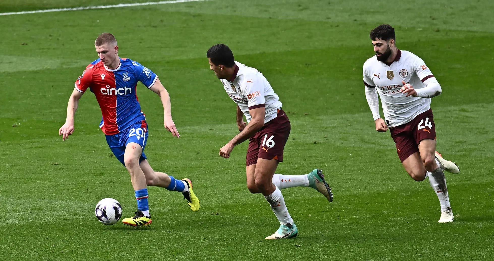 Crystal Palace player running with the ball, two defenders chasing Crystal Palace player running with the ball, two defenders chasing