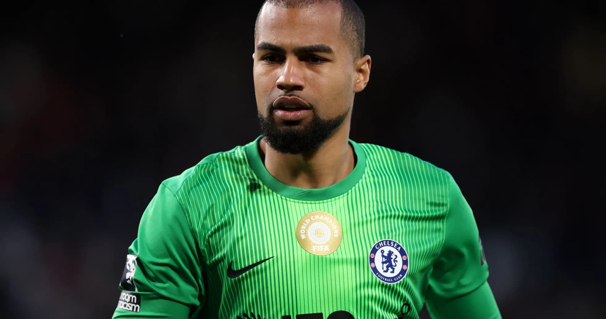 Goalkeeper in green kit during match action Goalkeeper in green kit during match action