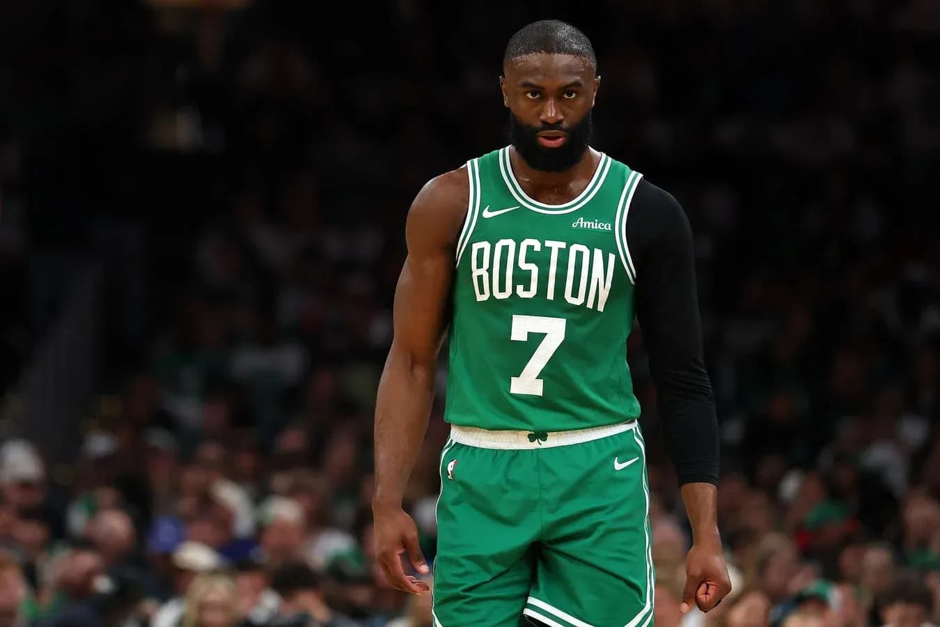 Basketball player in Boston Celtics uniform on court Basketball player in Boston Celtics uniform on court