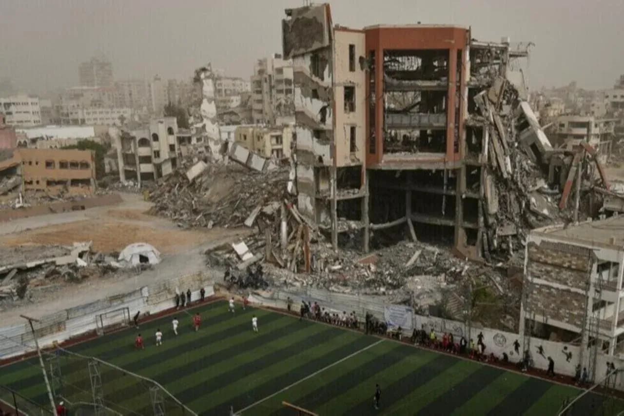 Football match taking place near destroyed buildings Football match taking place near destroyed buildings