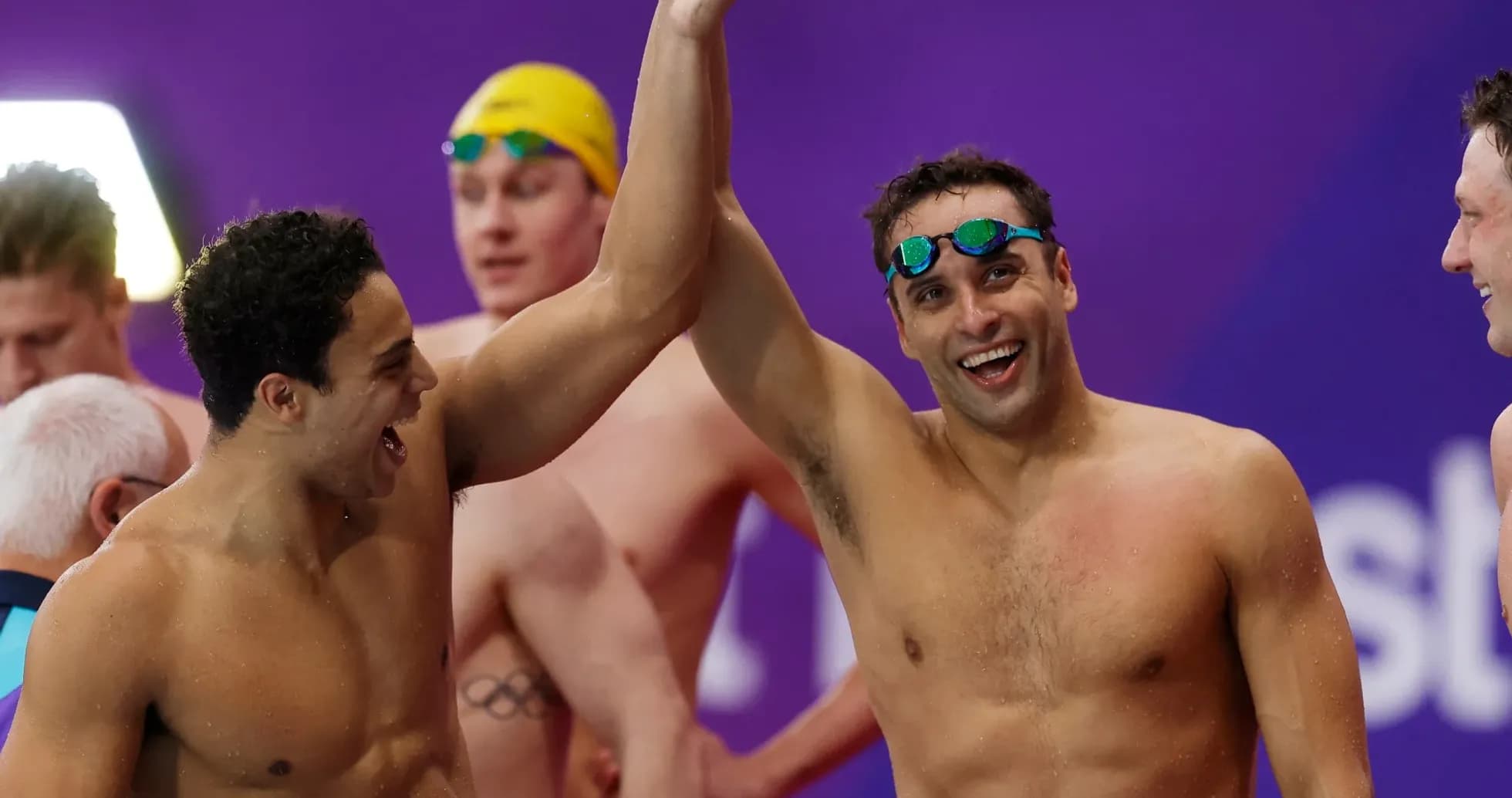 Two swimmers celebrating together after competition Two swimmers celebrating together after competition