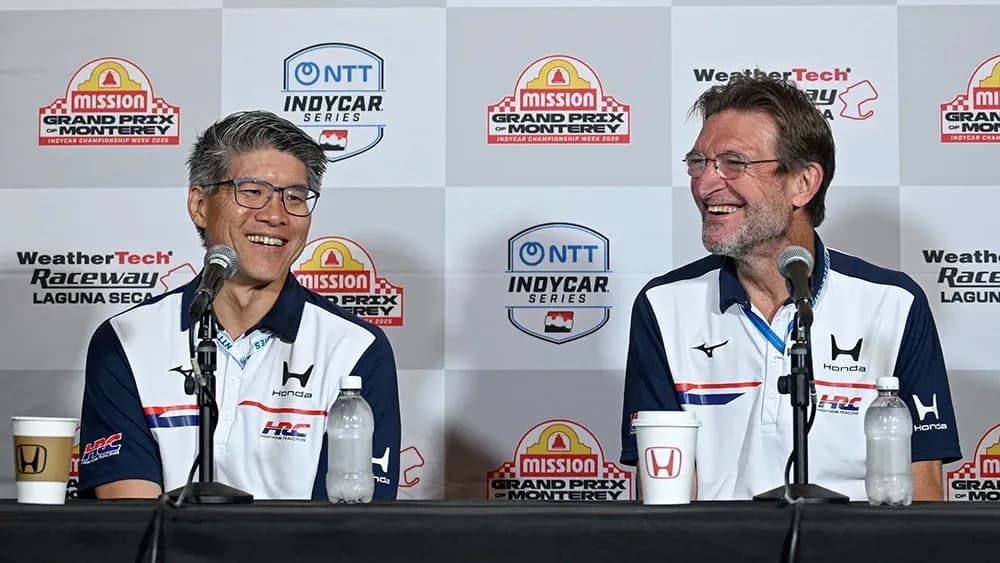 Two speakers at a press conference for IndyCar series Two speakers at a press conference for IndyCar series