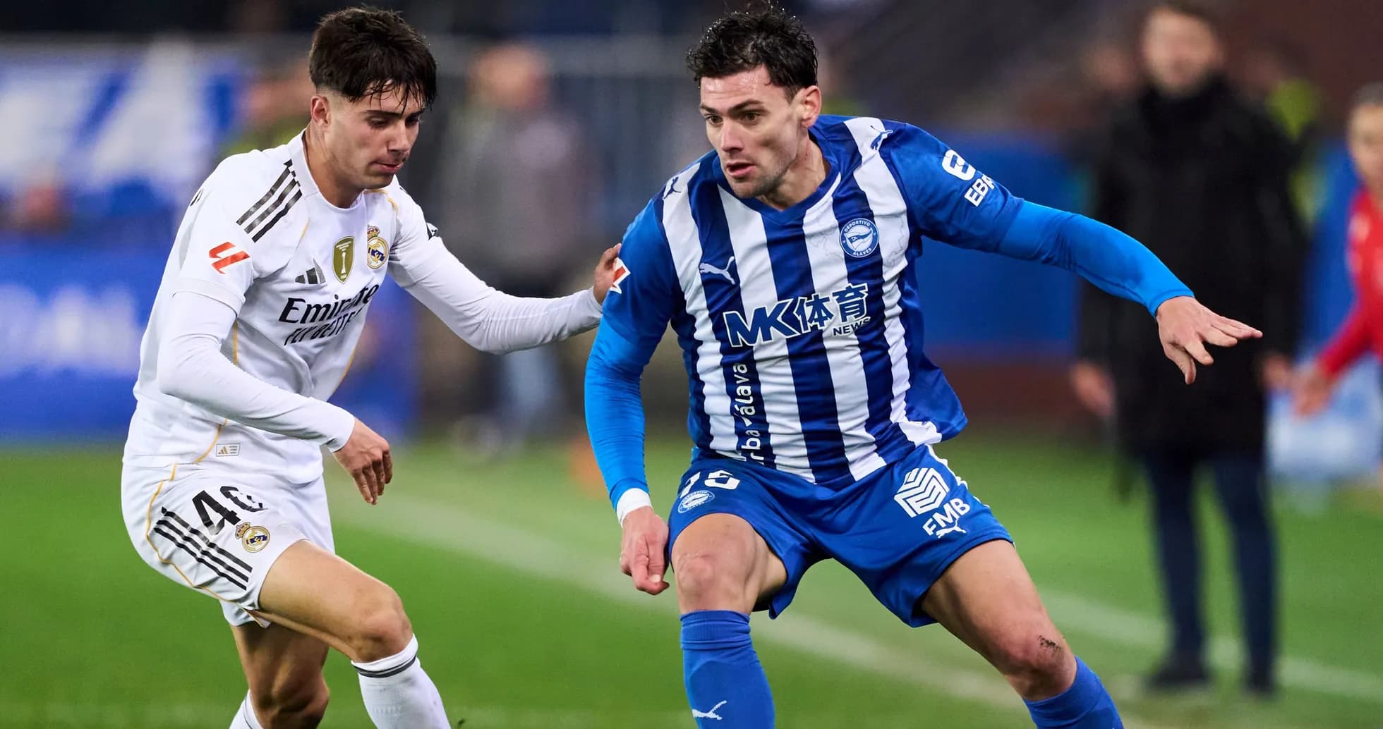 Two players competing for the ball during a match Two players competing for the ball during a match
