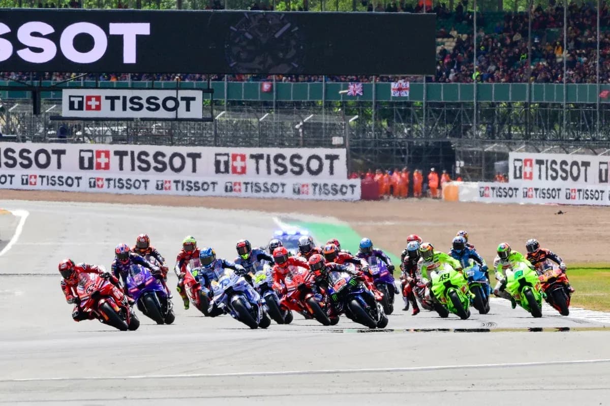 Motorsport race with multiple riders competing on track Motorsport race with multiple riders competing on track