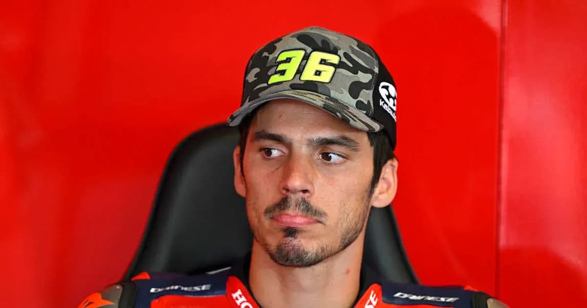 Motorsport athlete wearing cap in team garage Motorsport athlete wearing cap in team garage