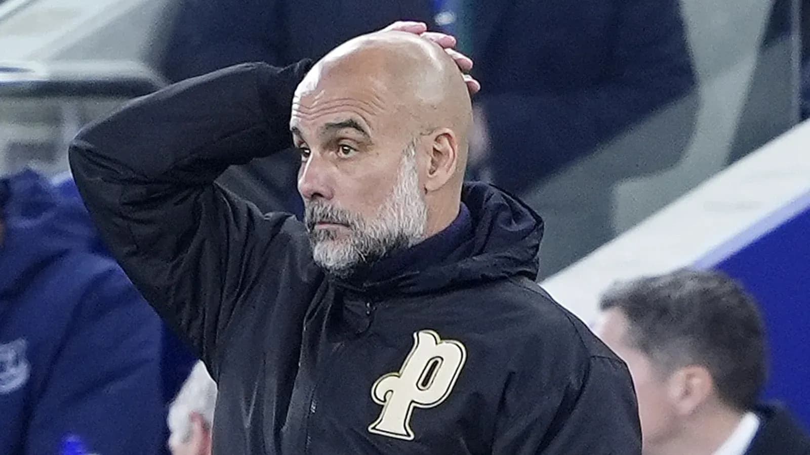 Bald coach with hand on head during match Bald coach with hand on head during match