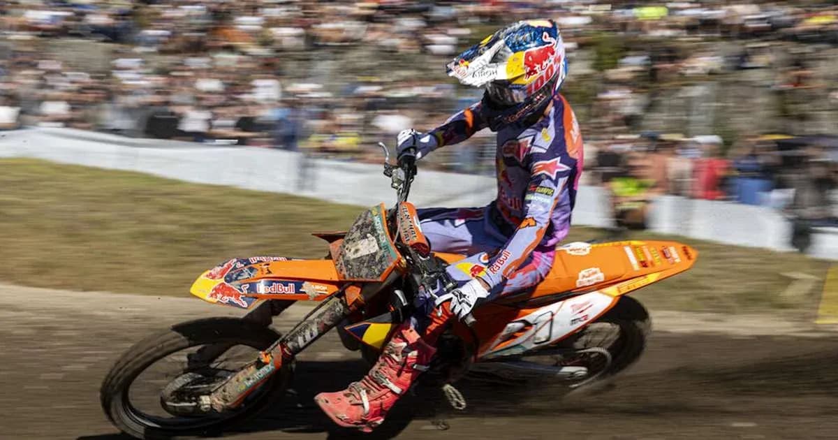 Motocross rider navigating a dirt track at event Motocross rider navigating a dirt track at event