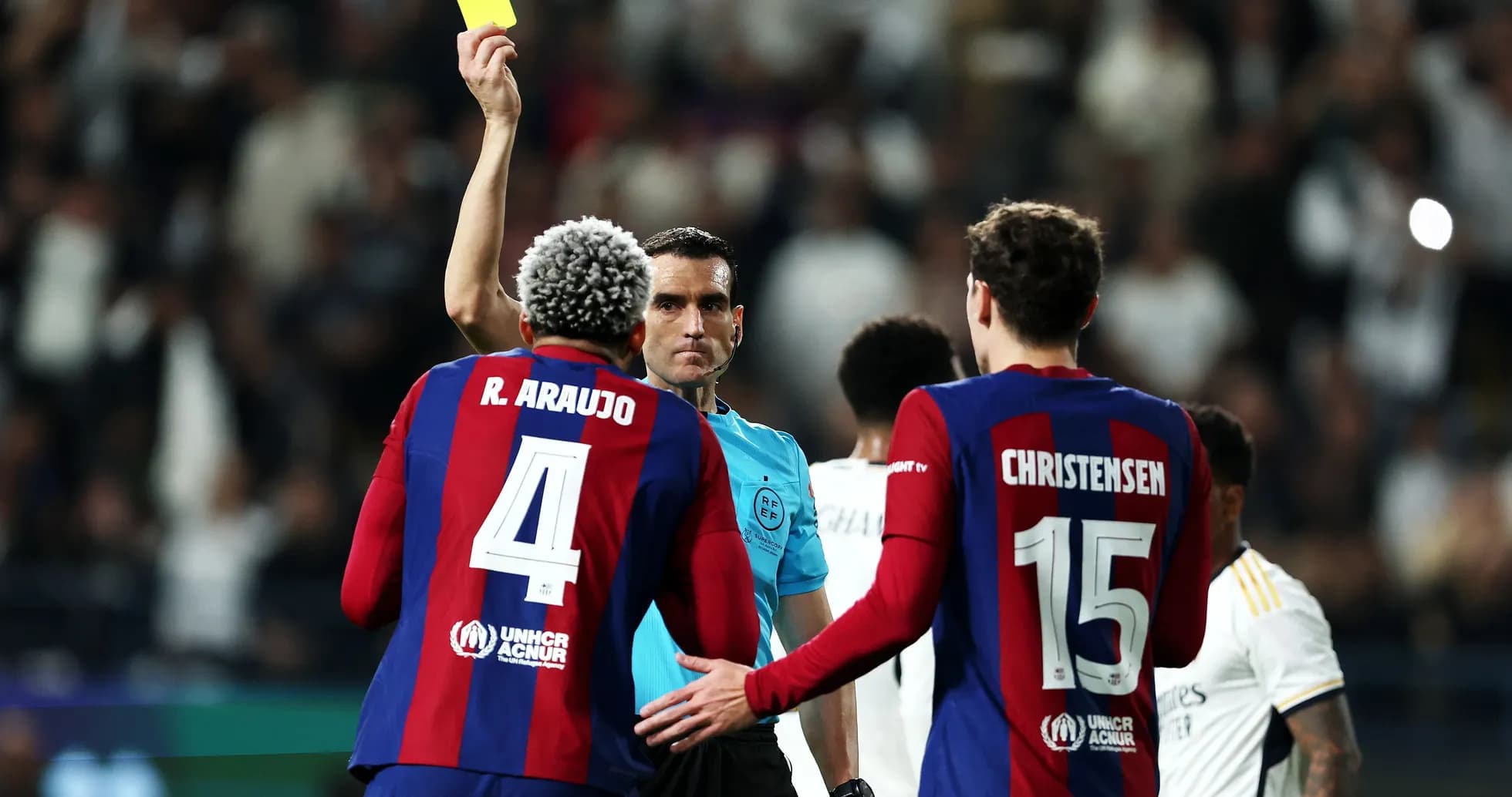 Referee showing yellow card to Barcelona player Referee showing yellow card to Barcelona player