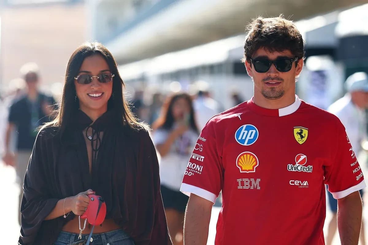 Couple walking at motorsport event, wearing sunglasses Couple walking at motorsport event, wearing sunglasses